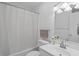 Bright bathroom with a shower-tub combo, white vanity and commode, plus decorative lighting at 5933 Rahnavard Blvd., Myrtle Beach, SC 29588