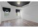 Spacious bedroom with dark, patterned ceiling, wood floor, two windows, and sheer black curtains at 5933 Rahnavard Blvd., Myrtle Beach, SC 29588