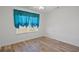 This bedroom features modern wood flooring, natural light and a large window with stylish valance at 5933 Rahnavard Blvd., Myrtle Beach, SC 29588