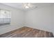 A simple bedroom with hardwood flooring, a large window, neutral paint, and ceiling fan at 5933 Rahnavard Blvd., Myrtle Beach, SC 29588