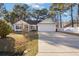 Brick ranch home with attached garage and landscaped yard at 5933 Rahnavard Blvd., Myrtle Beach, SC 29588