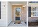 Inviting front entry with brick accents and a welcome mat at 5933 Rahnavard Blvd., Myrtle Beach, SC 29588