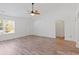 Well-lit living room with wood floors, a ceiling fan, and access to other areas of the house at 5933 Rahnavard Blvd., Myrtle Beach, SC 29588