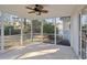 Relaxing screened-in porch with ceiling fan, offering serene outdoor views and natural light at 5933 Rahnavard Blvd., Myrtle Beach, SC 29588