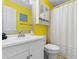 Clean bathroom with yellow walls and white vanity at 6000 N Ocean Blvd. # 317, North Myrtle Beach, SC 29582