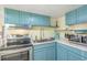 Teal kitchen cabinets, stainless steel appliances, marble countertop at 6001-1654 South Kings Hwy., Myrtle Beach, SC 29575