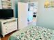 Bedroom with TV, white dresser, and bed with teal bedding at 6001-1655 South Kings Hwy., Myrtle Beach, SC 29575