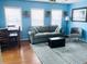 Living room with gray sofa, dining area, and large windows at 6001-1655 South Kings Hwy., Myrtle Beach, SC 29575