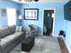 Living room with gray couch, comfy chair, and large TV at 6001-1655 South Kings Hwy., Myrtle Beach, SC 29575