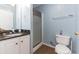 Bathroom with a white vanity, granite countertop, and shower featuring blue walls at 6001-1709 South Kings Hwy., Myrtle Beach, SC 29575
