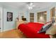 Cozy bedroom with a red bedspread, a seahorse wall decoration, and soft, natural light at 6001-1709 South Kings Hwy., Myrtle Beach, SC 29575