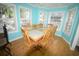Bright dining room with large windows, wood floors, and seating for eight at 6001-1709 South Kings Hwy., Myrtle Beach, SC 29575