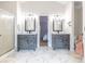 Elegant bathroom with double vanities, marble floors, and a walk-in shower at 603 Hatteras River Rd., Myrtle Beach, SC 29588