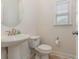 Clean and bright half bathroom with pedestal sink and toilet at 6172 Catalina Dr. # 911, North Myrtle Beach, SC 29582