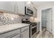 Modern kitchen with gray cabinets, granite countertops, and stainless steel appliances at 640 Woodside Dr., Conway, SC 29526