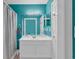 Teal bathroom with white vanity and shower at 670 2Nd Ave. N, North Myrtle Beach, SC 29582