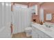 Bathroom with shower/tub, white vanity, and pink walls at 670 2Nd Ave. N, North Myrtle Beach, SC 29582