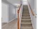 Staircase with wood railing and beige carpeting at 670 2Nd Ave. N, North Myrtle Beach, SC 29582