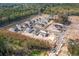 Aerial view of new homes under construction surrounded by a lush tree canopy at 690 Choctaw Dr., Conway, SC 29526