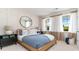 Bright bedroom with board and batten accent wall, large windows and a cozy blue bedspread at 690 Choctaw Dr., Conway, SC 29526
