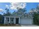 Charming single-story home with green siding, white trim, a two-car garage, and well-manicured landscaping at 690 Choctaw Dr., Conway, SC 29526