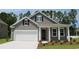 Gray siding two-story house with white garage door and red front door at 690 Choctaw Dr., Conway, SC 29526