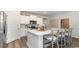 Bright kitchen with white cabinetry, an island with barstool seating, and stainless steel appliances at 690 Choctaw Dr., Conway, SC 29526