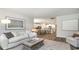 Spacious living room with hardwood floors, a comfortable couch, and an open layout to the kitchen at 690 Choctaw Dr., Conway, SC 29526