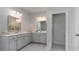 Double vanity bathroom with gray cabinets and a large mirror at 715 Choctaw Dr., Conway, SC 29526