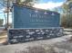 Elegant entrance sign for 'The Reserve at Wild Horse,' est. 2022, with stone and wooden accents at 715 Choctaw Dr., Conway, SC 29526