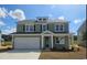Charming two-story home featuring a two-car garage, a light-green exterior, and a well-manicured lawn at 715 Choctaw Dr., Conway, SC 29526