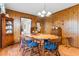 Charming dining room with wood-paneled walls and a wood table with blue chairs at 7152 Highway 134, Conway, SC 29527