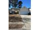 House exterior showcasing a two-car garage and neat landscaping at 803 Sultana Dr., Little River, SC 29566