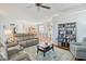 Open living room with hardwood floors, a fireplace, and built-in shelving at 858 Edgewater Dr., Murrells Inlet, SC 29576