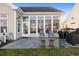 Back patio with sunroom, grill, and stone patio at 858 Edgewater Dr., Murrells Inlet, SC 29576