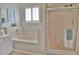 Bathroom showcasing a tub, glass-enclosed shower and shell decor at 905 Adaline Ct., Myrtle Beach, SC 29579