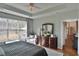 Sunlit bedroom with a large window, dark wood furniture and natural lighting at 905 Adaline Ct., Myrtle Beach, SC 29579