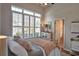 Bright bedroom with shuttered windows and a doorway to the bath features light and airy colors at 905 Adaline Ct., Myrtle Beach, SC 29579