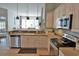 Bright kitchen with white cabinets, stainless steel dishwasher, and an adjoining living space at 905 Adaline Ct., Myrtle Beach, SC 29579