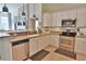 Open kitchen with stainless steel appliances, white cabinets, and an adjoining living space at 905 Adaline Ct., Myrtle Beach, SC 29579