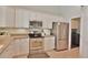 Modern kitchen with stainless steel appliances, white cabinetry, and a view of the laundry room at 905 Adaline Ct., Myrtle Beach, SC 29579