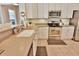 Bright kitchen featuring a stainless steel oven, white cabinets, and a sink with faucet at 905 Adaline Ct., Myrtle Beach, SC 29579