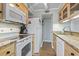 Full kitchen with white appliances and granite countertops at 9661 Shore Dr. # C-14, Myrtle Beach, SC 29572