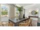 Spacious dining area with large windows and a rustic wooden table at 114 Ranch Haven Dr., Murrells Inlet, SC 29576