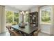 Dining room with large windows, view of backyard, and a dark wooden table at 114 Ranch Haven Dr., Murrells Inlet, SC 29576