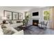 Living room with a cozy fireplace and large windows offering natural light at 114 Ranch Haven Dr., Murrells Inlet, SC 29576