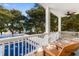 Balcony with wooden chairs and pool view at 116B 15Th Ave. N, Surfside Beach, SC 29575