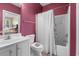 Bathroom with a toilet, shower/tub combo, and vanity with red walls at 131 Waypoint Ridge Ave. # Q13, Little River, SC 29566