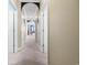 A hallway with carpeted floor and archways leading to different rooms at 131 Waypoint Ridge Ave. # Q13, Little River, SC 29566