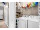 Stackable washer and dryer in a well-lit laundry room with extra shelving at 131 Waypoint Ridge Ave. # Q13, Little River, SC 29566